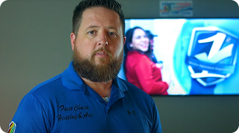 First Choice Heating & Air technician standing in front of company presentation screen